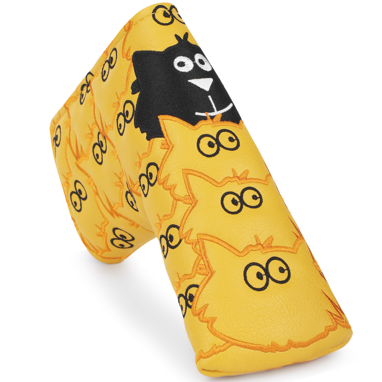 A close view of a yellow cover shows a black cartoon monster face with white eyes and an orange outline.
