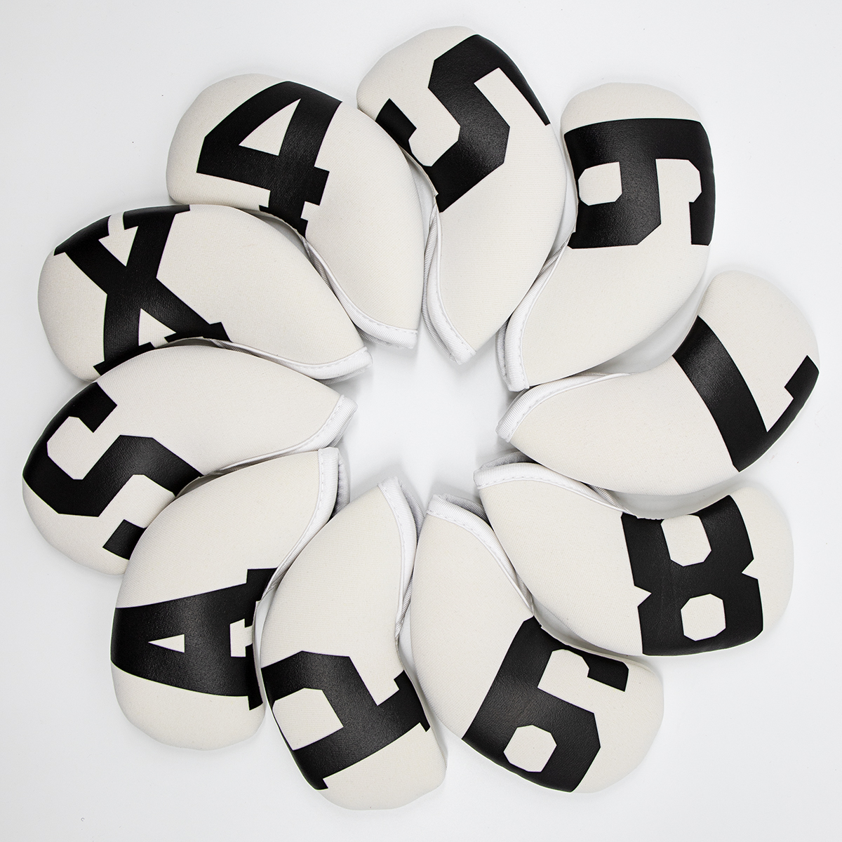 White covers with black numerals and letters form a circle around an empty center.