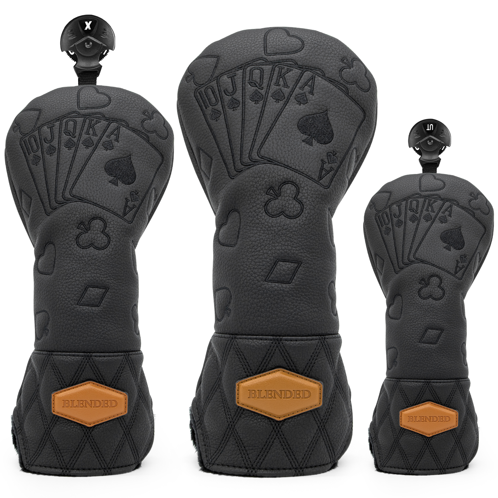 Three black covers embossed with playing cards and card-suit symbols, each with a small orange badge.