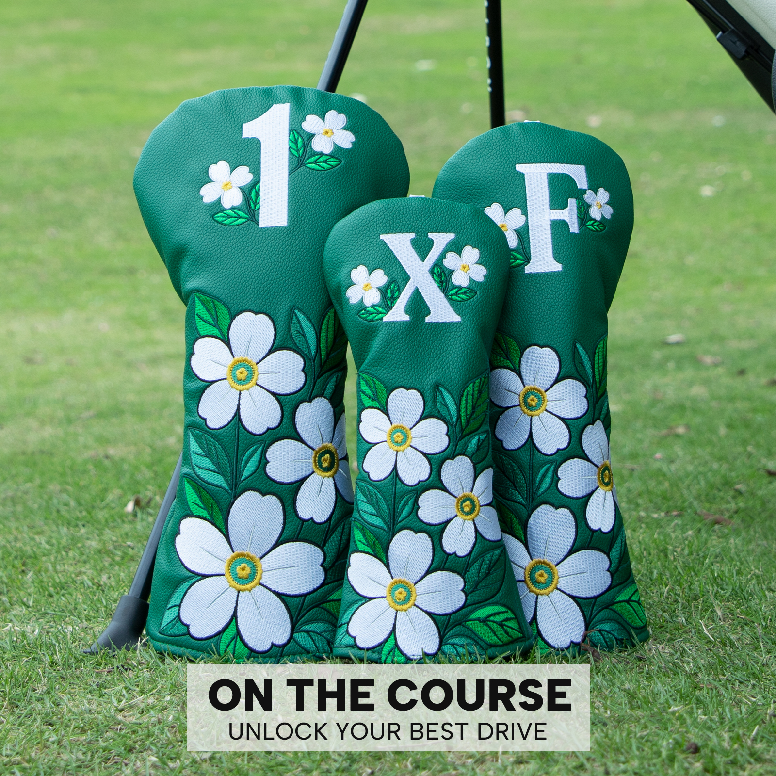 Three green floral covers stand on grass beneath the visible image caption “ON THE COURSE UNLOCK YOUR BEST DRIVE.”