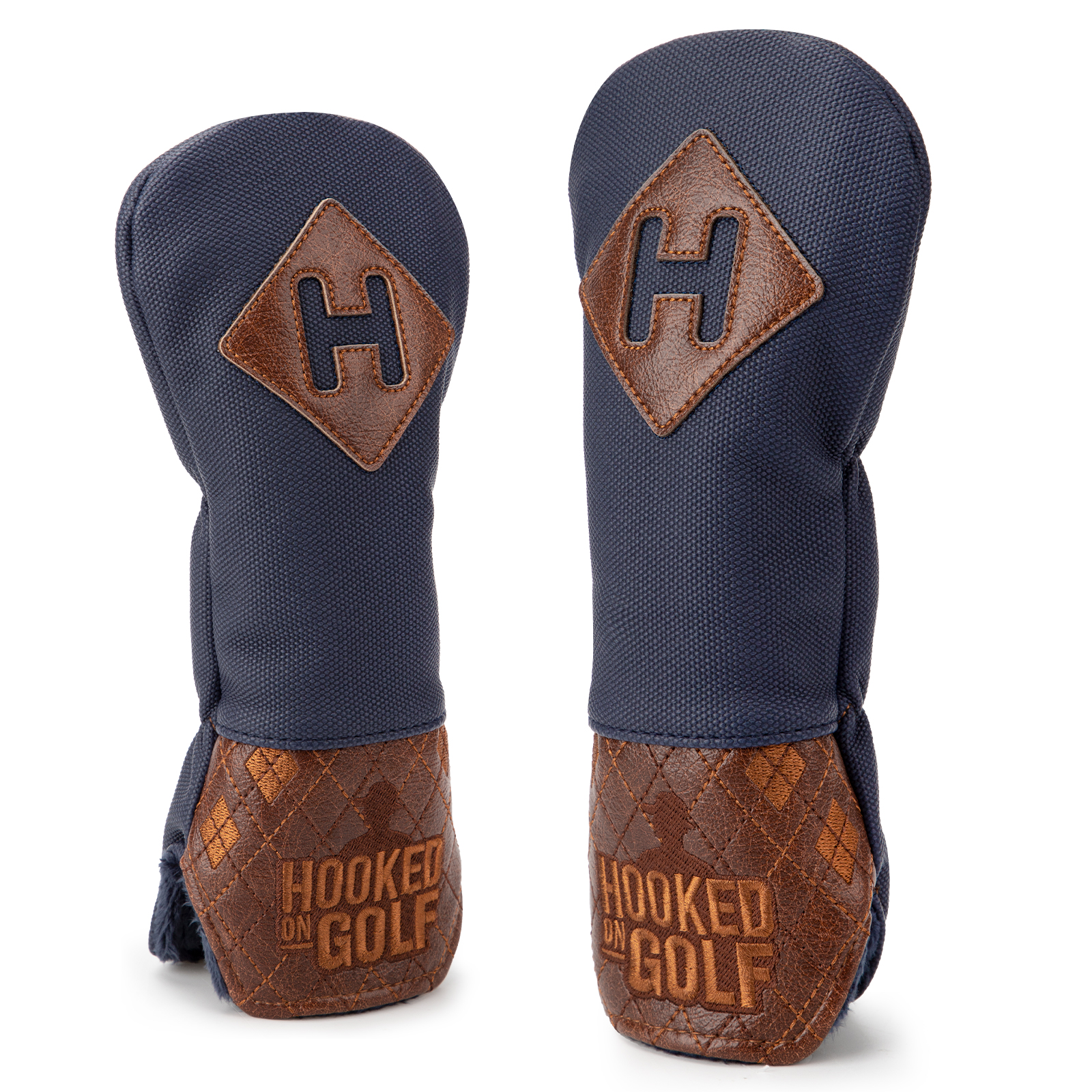 Two navy covers with brown patches marked “H” and visible “HOOKED ON GOLF” lettering on their patterned lower sections.