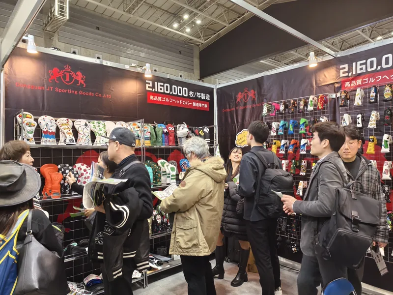 People browsing golf accessories beside an indoor aisle