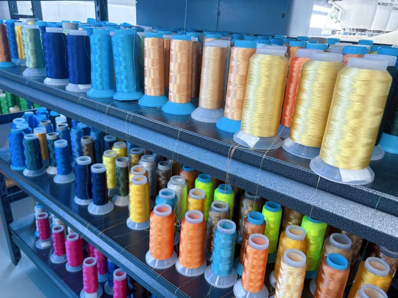 Colorful thread cones stored on shelving