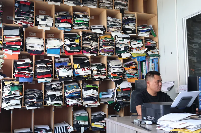 Shelves of headcover materials beside a workstation