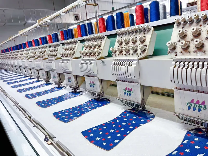 Embroidery machine stitching patterned fabric