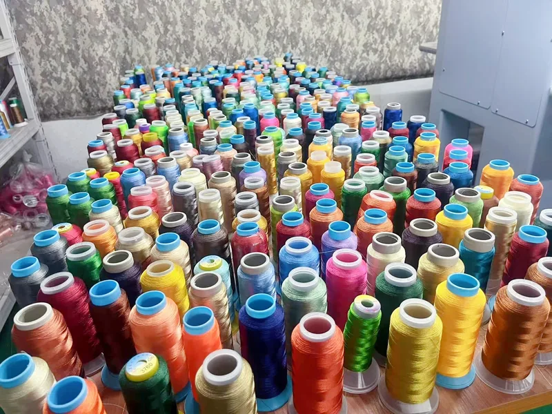 Red, blue, yellow, white, and black embroidery-thread cones
